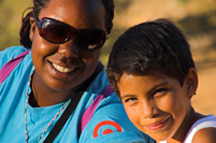 Counselor and young boy posing for a picture