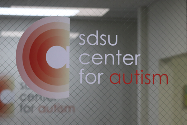 lower-case a surrounded by concentric white and red semi-circles next to text that says SDSU Center for Autism