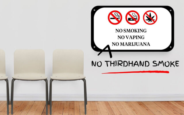 A room that contains three chairs and a sign that reads “NO SMOKING NO VAPING NO MARIJUANA” with a hand-drawn caret adding the words “NO THIRDHAND SMOKE,” underlined in red.