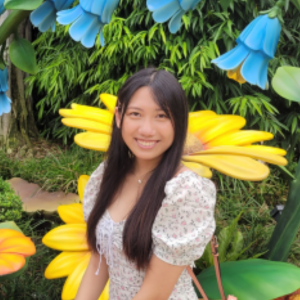 Student headshot in front of flowers