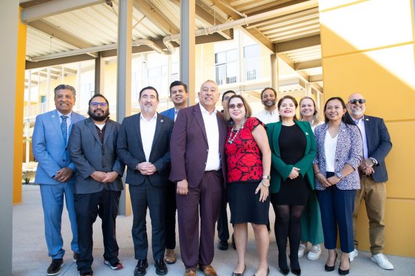 11 SWC members pose with President de la Torrie outside.